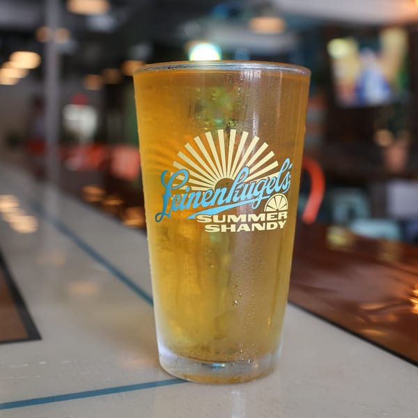 A frosty glass of Leinenkugel's Summer Shandy beer on a bar top at Spycoast Kitchen & Cocktails.